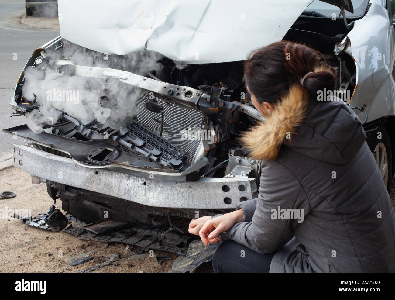 Car crash from car accident on the road. Woman feeling pain after car