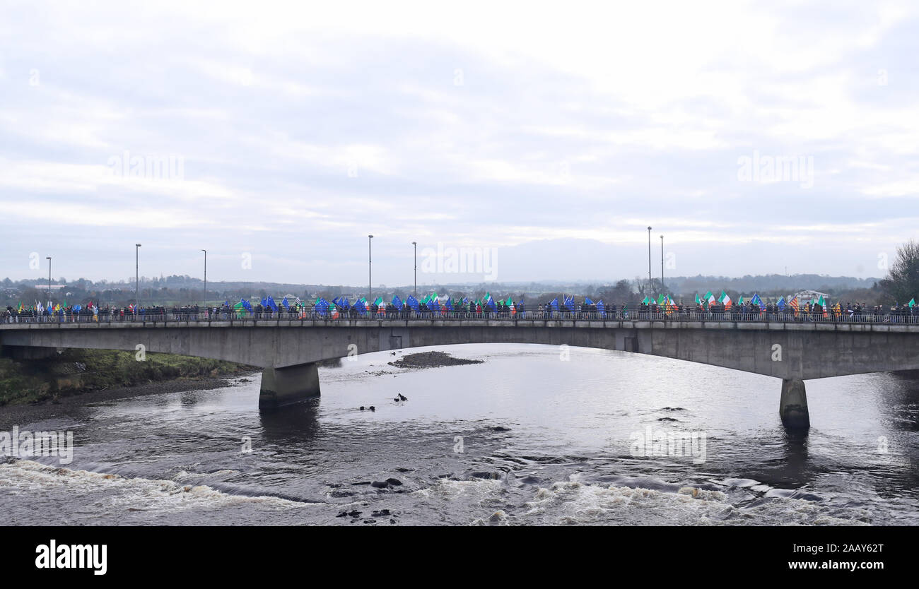 People take part in an Irish unity march as they cross the Lifford Bridge, from Donegal, which marks the border between Strabane in County Tyrone, Northern Ireland, and Lifford in County Donegal in the Republic of Ireland. Stock Photo