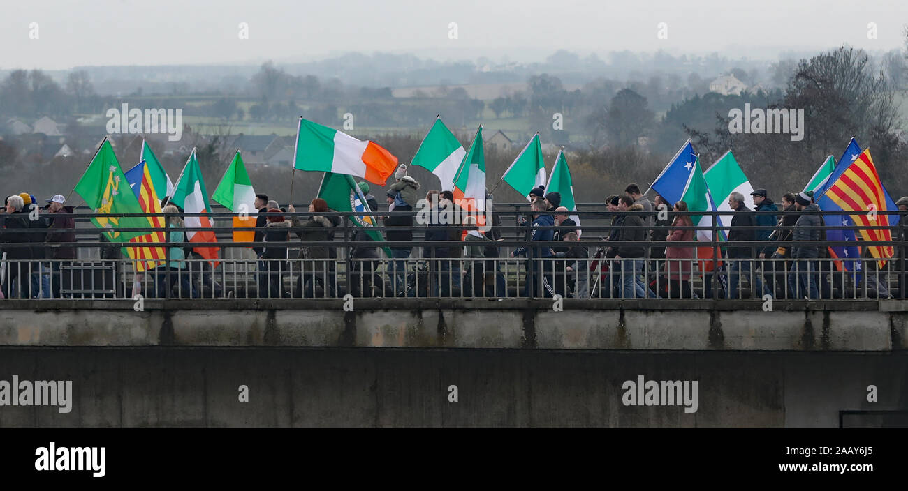 People take part in an Irish unity march as they cross the Lifford Bridge, from Donegal, which marks the border between Strabane in County Tyrone, Northern Ireland, and Lifford in County Donegal in the Republic of Ireland. Stock Photo