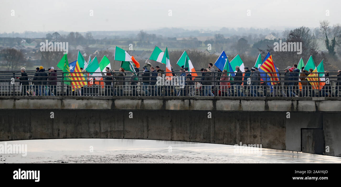 People take part in an Irish unity march as they cross the Lifford Bridge, from Donegal, which marks the border between Strabane in County Tyrone, Northern Ireland, and Lifford in County Donegal in the Republic of Ireland. Stock Photo