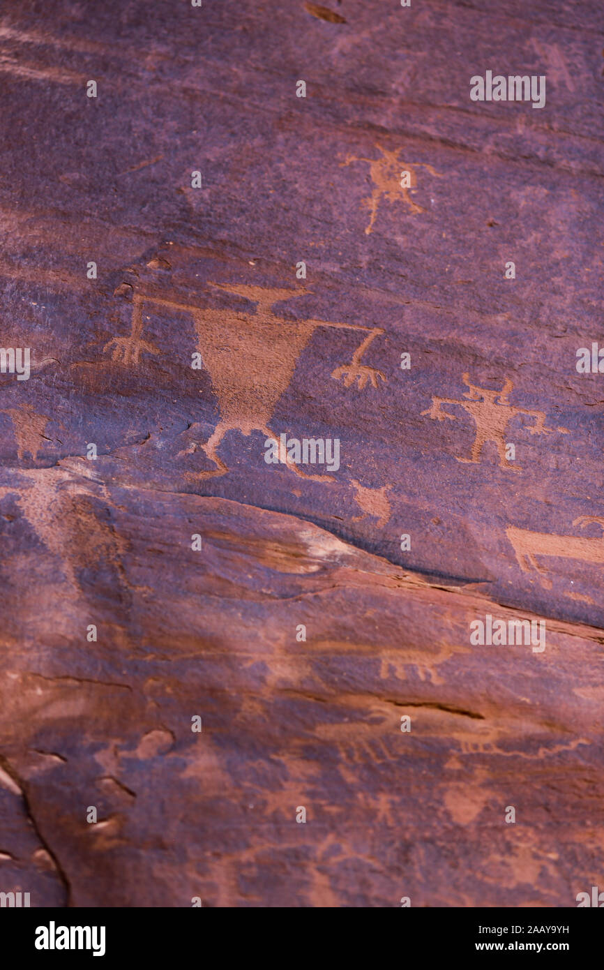 Petroglyph art rock carvings by Native Americans in red desert canyon