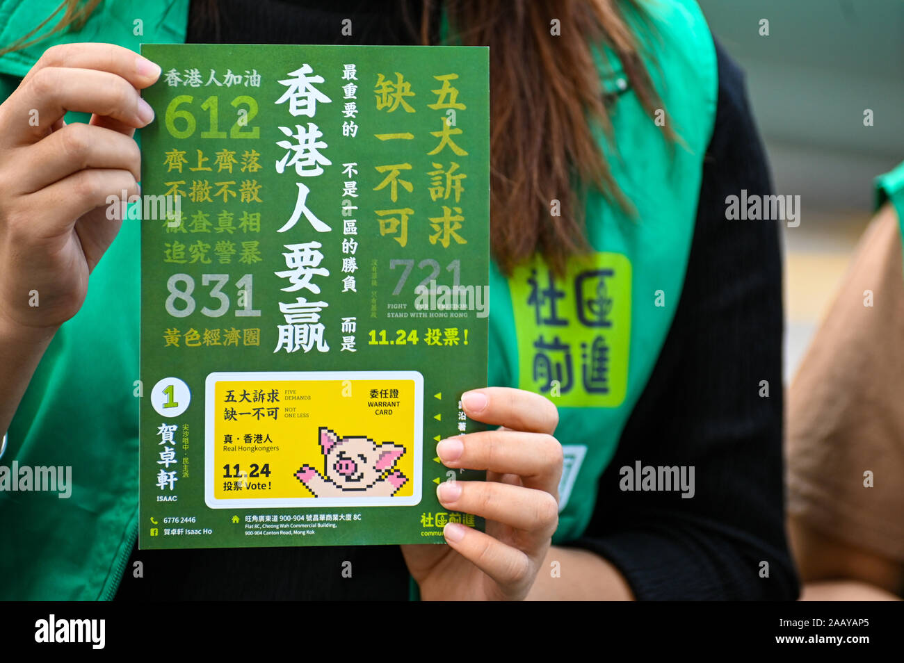 Hong Kong, China. 24th Nov, 2019. A campaigner for pro-democracy candidate Isaac Ho held up a flyer containing many references to Hong Kong's protest movement during the city's District Council elections on November 24, 2019. Photo by Thomas Maresca/UPIPhoto by Thomas Maresca/UPI Credit: UPI/Alamy Live News Stock Photo
