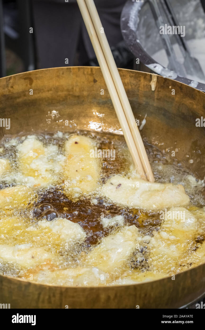 Deep fried banana in a pan with hot oil Stock Photo