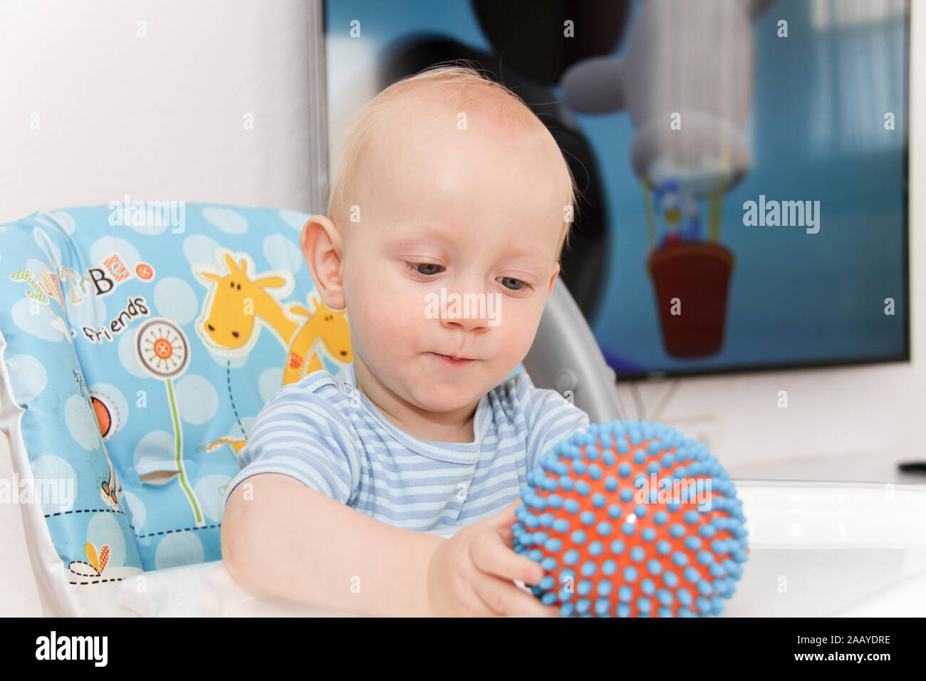 Photo of the One year Baby watching cartoons on TV and playing Stock
