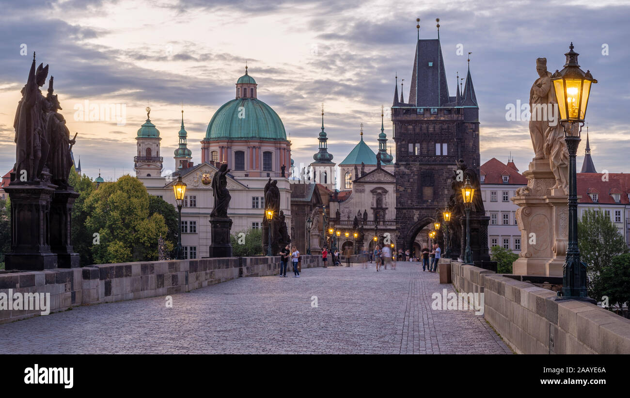 The Old Town bridge tower, statues and lanterns lit up at night on ...