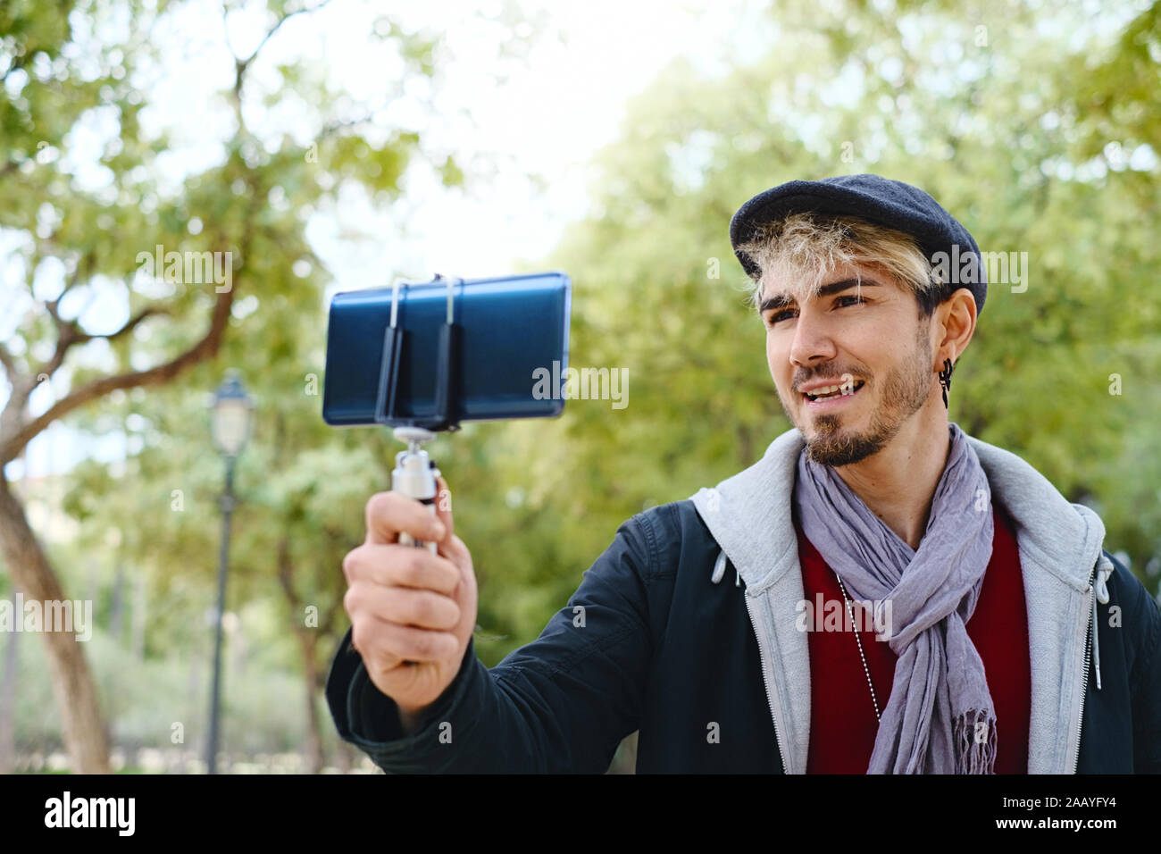 Millennial Man Recording Vlog With Mobile Phone For Social Media Stock Photo
