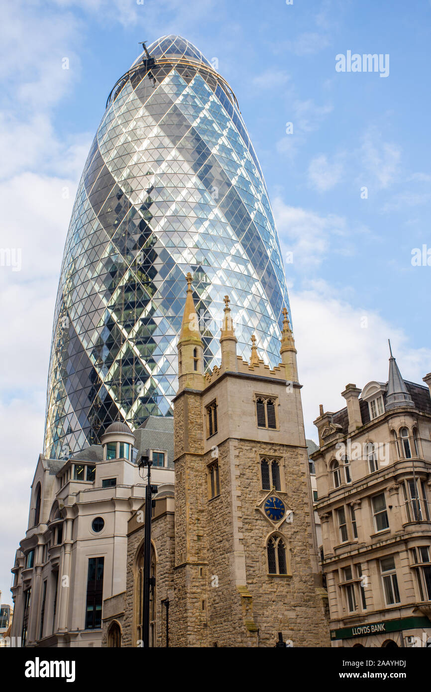 30 St Mary Axe, the Gherkin tower and St Andrew Undershaft Church in London, England Stock Photo