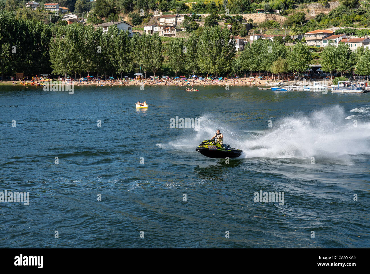 Praia Fluvial Bitetos, Portugal - 17 August 2019: Sea Doo watercraft rider in the river by the Bitetos beach in Douro valley Stock Photo