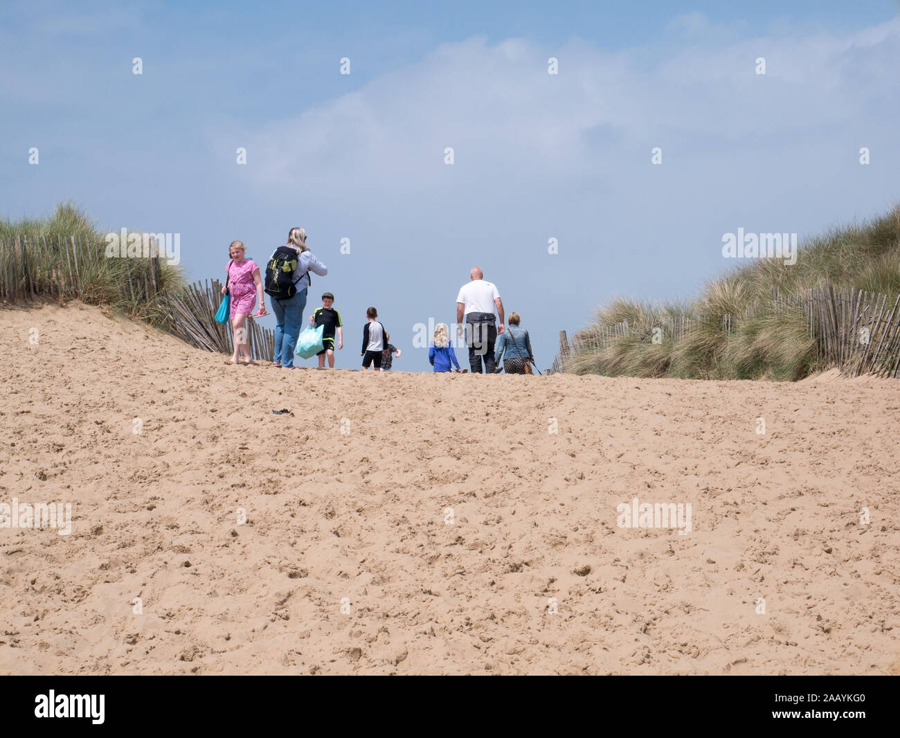 People walking over sand dune Stock Photo - Alamy