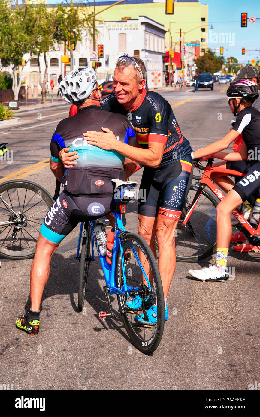 Two competitors and friends give each other a hug at the 100mile El Tour de Tucson bicycle race Stock Photo