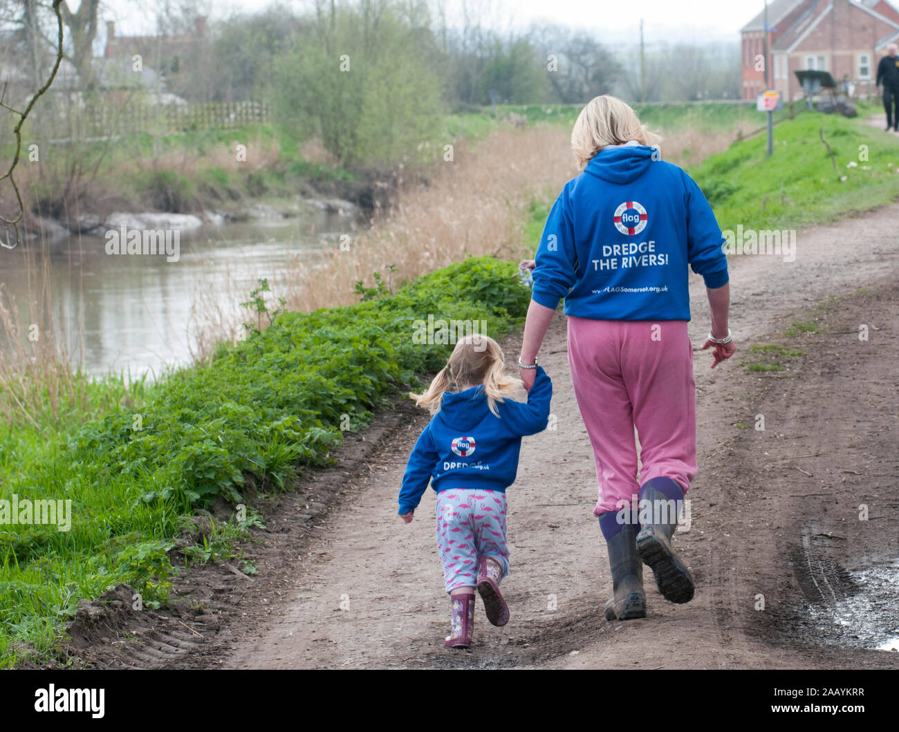 Dredging begins on the local river to prevent further flooding at Moreland in Somerset. Victims of the recent flooding Bryony Sadler and her three year old Elsa are hoping that the dredging of the the river will prevent future flooding. March 2014 Stock Photo