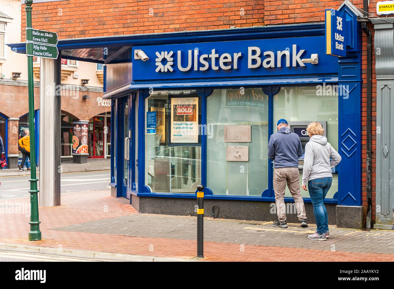 People withdraw money from an Ulster Bank ATM in Killarney, County Kerry, Ireland. Stock Photo