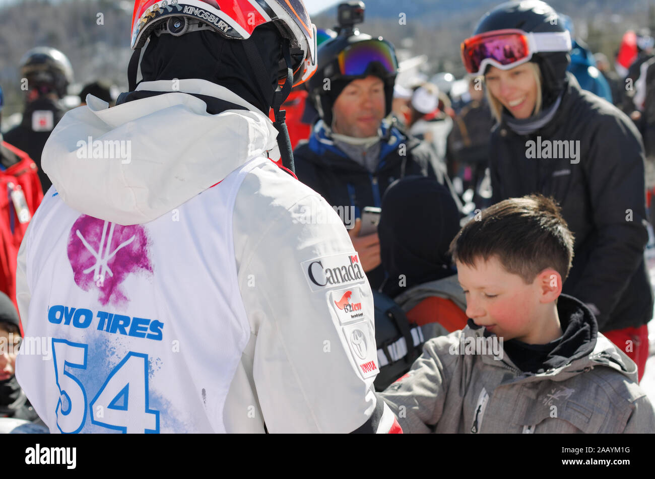 Quebec,Canada. World moguls champion, Mikael Kingsbury signing autographs for  a fan at the Canadian Moguls Championship Series presented by Toyota at Stock Photo