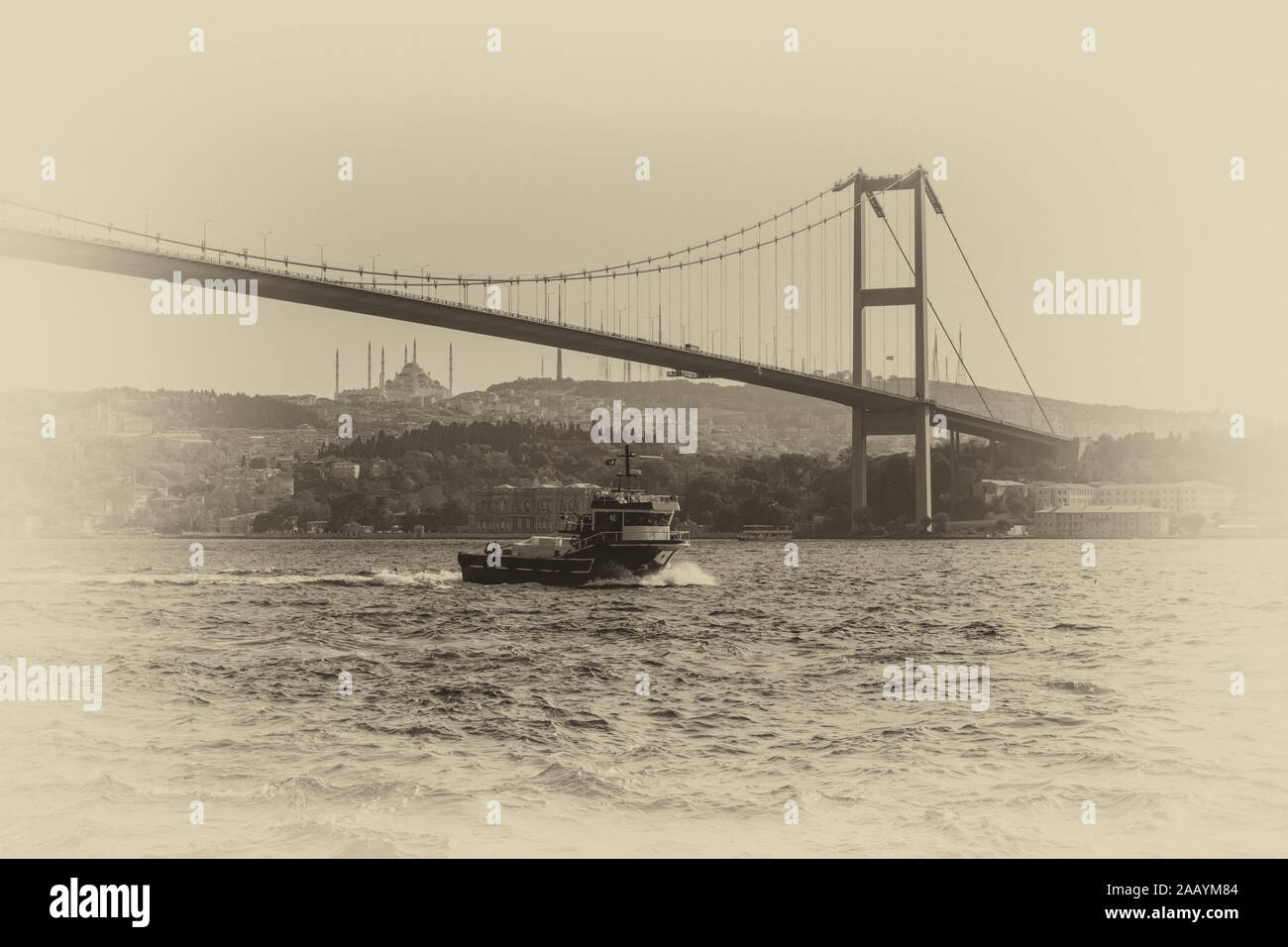 Bosphorus Bridge and a cargo ship, retro style photo, Istanbul Stock Photo
