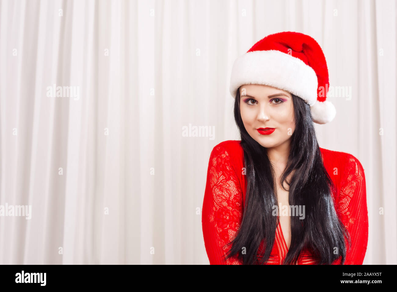 Woman wearing a Santa hat dressed in red lingerie Stock Photo