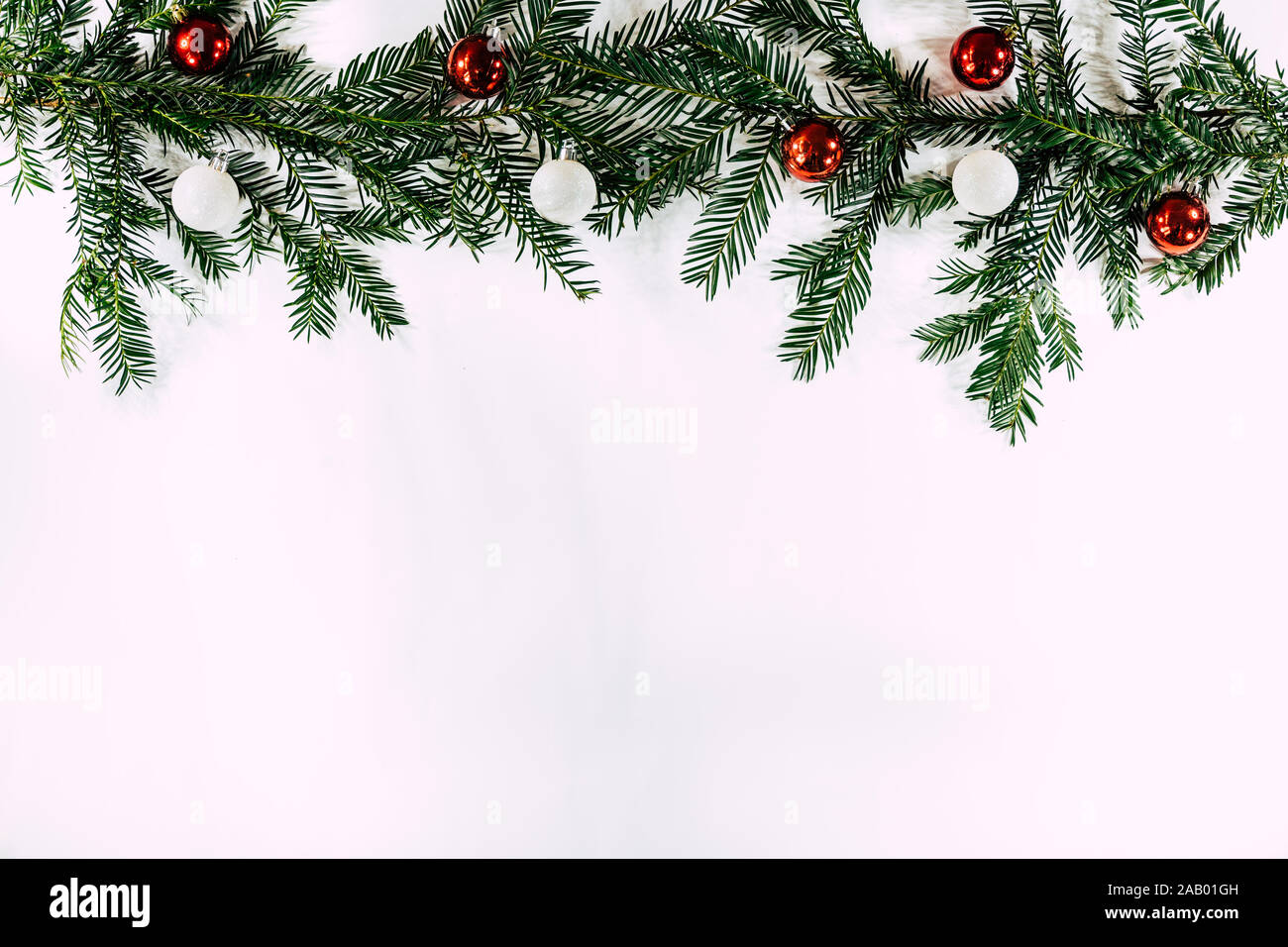Christmas Border with tree branch's and baubles on a white background Stock Photo