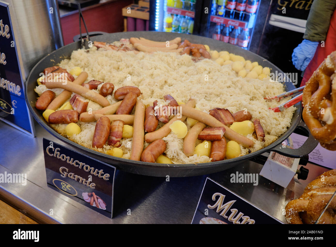 Large skillet full of Choucroute Garnie (sauerkraut) on display and for sale at a food stall at the Strasbourg Christmas Market Stock Photo