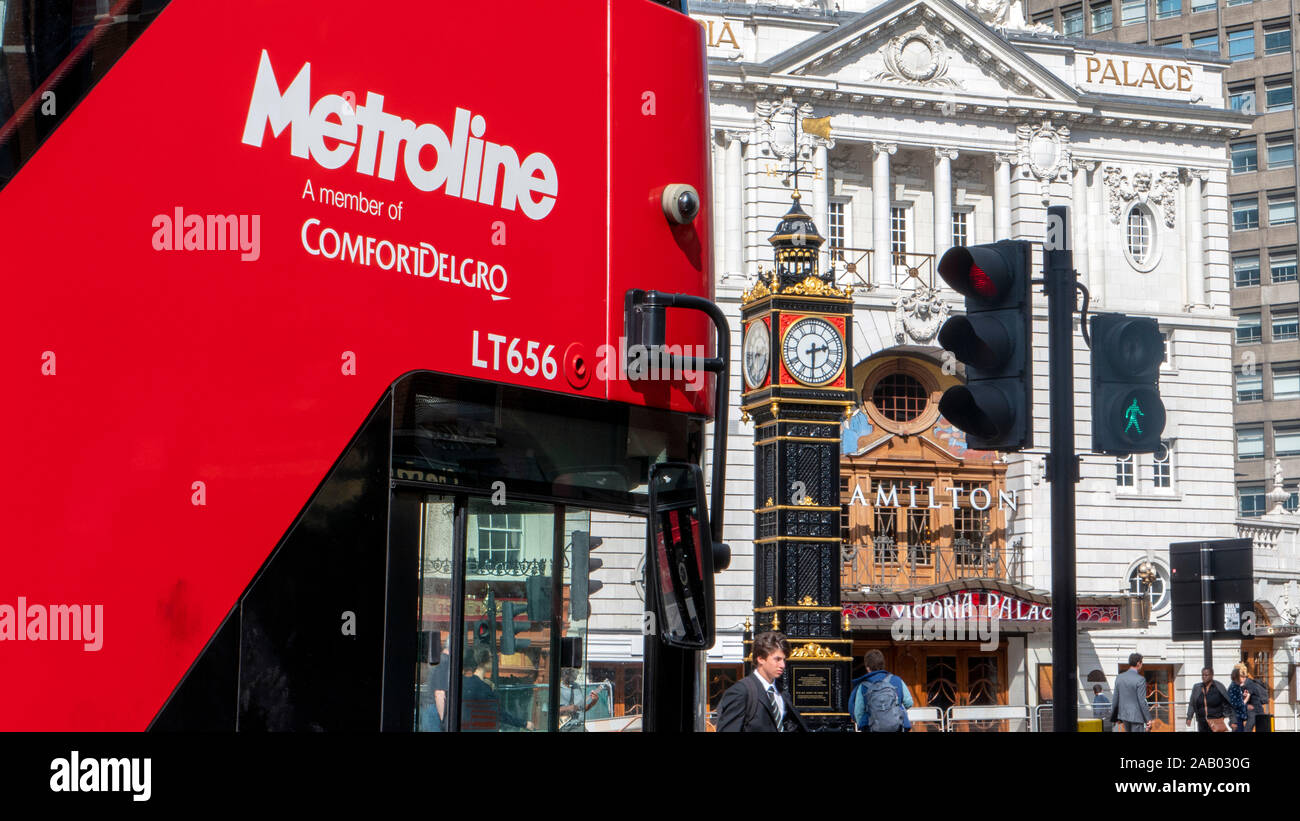 Red bus, a theatre and Little Ben clock tower Victoria London England Stock Photo