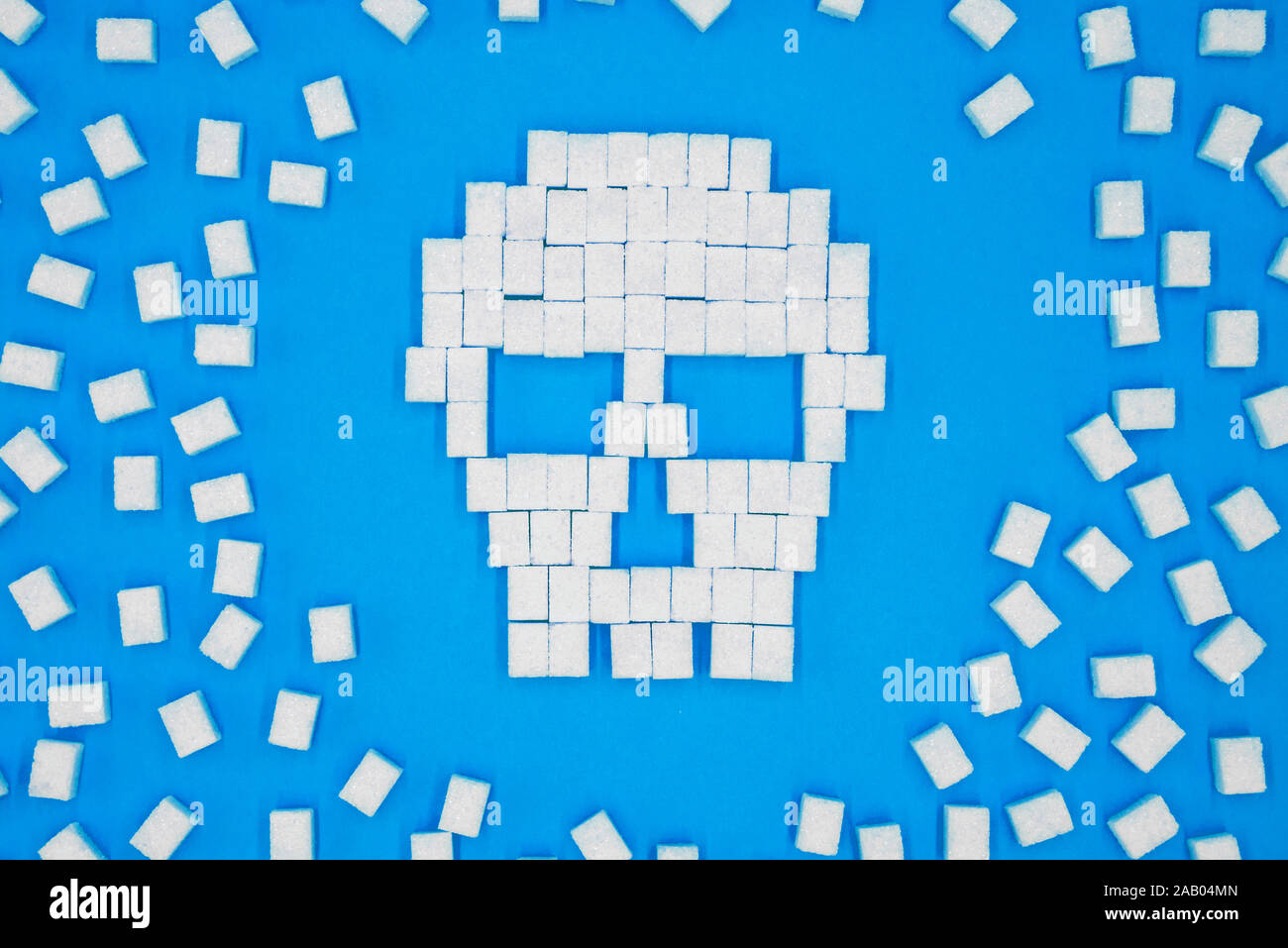 Sugar cubes laid out in shape of skull. Concept that sugar and sweets are dangerous. Sugar and sweet leads to diabetes. Stock Photo