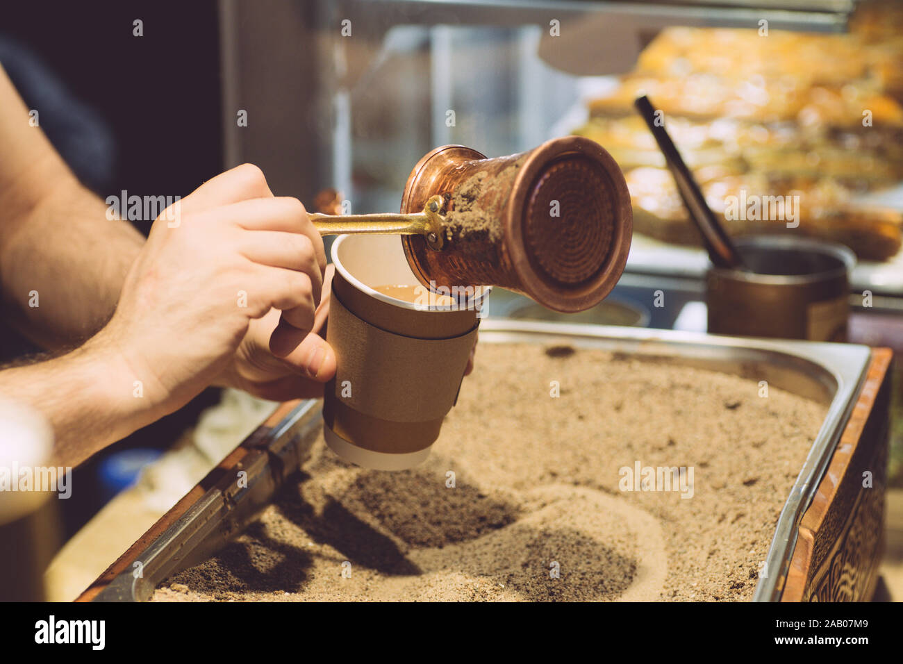 Brewing Turkish coffee on hot sand. The traditional method of making