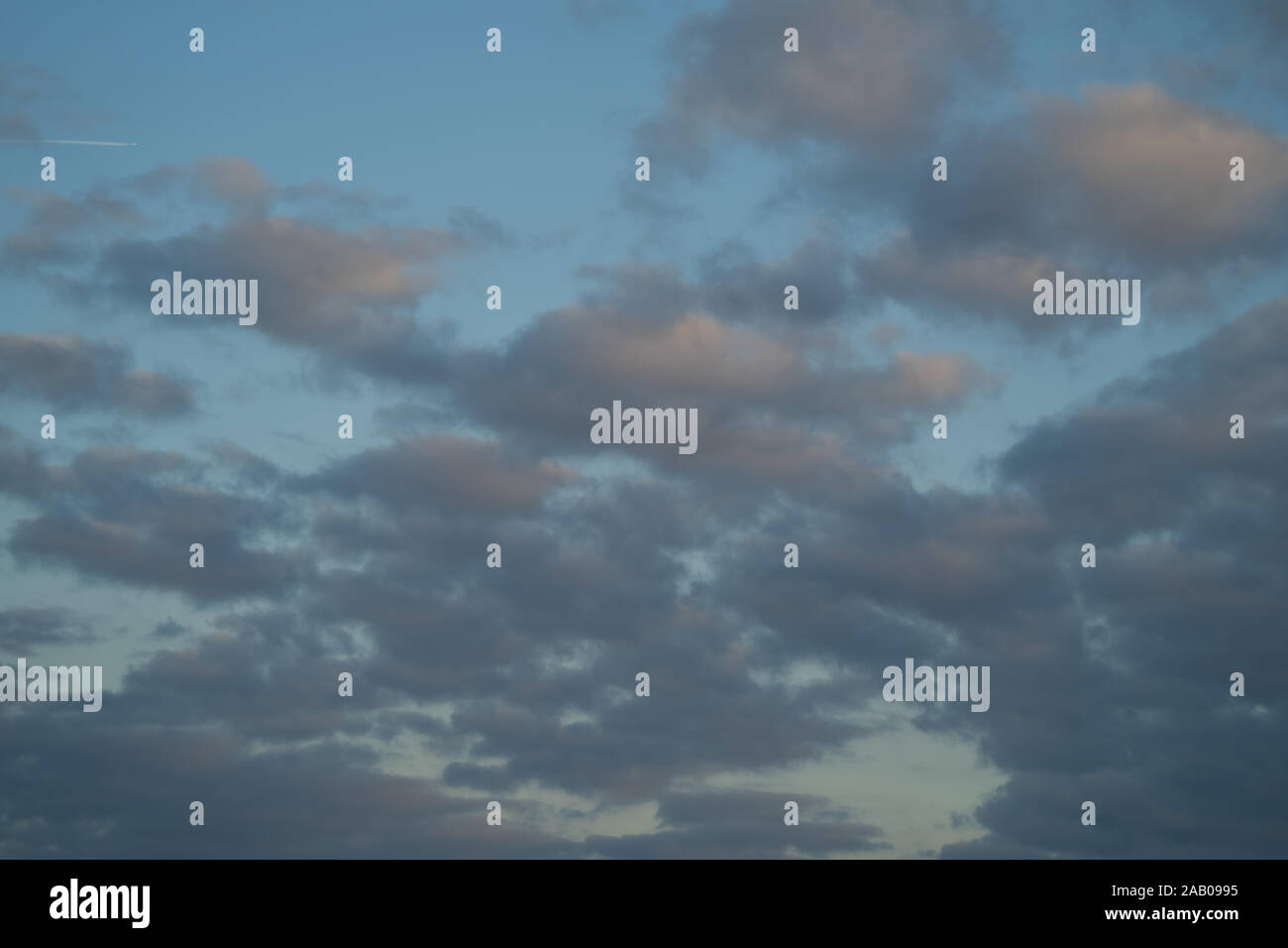 Mackerel sky. Blue sky with light broken cloud with the sun giving a