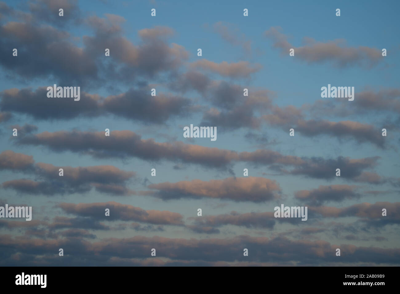 Mackerel sky. Blue sky with light broken cloud with the sun giving a