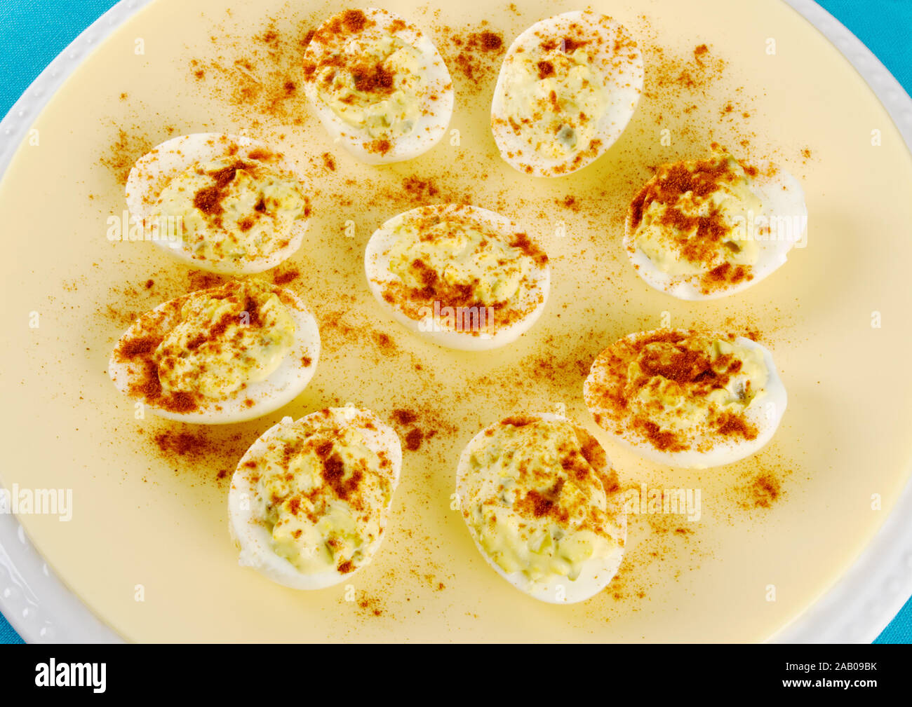 deviled egg appetizers served on double stacked plates with a colorful