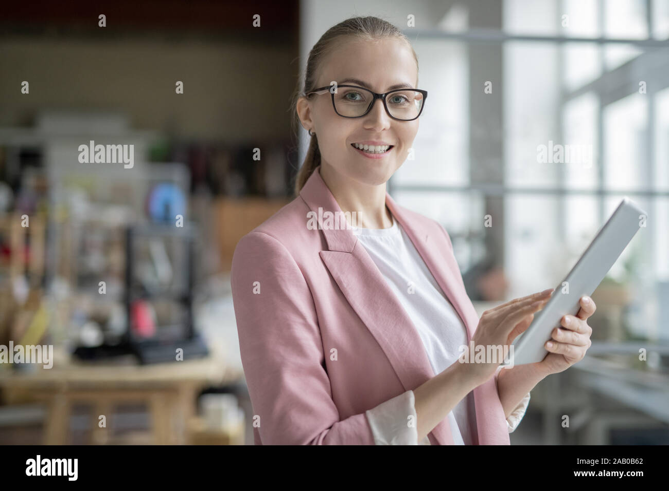 Successful businesswoman using digital tablet while preparing presentation Stock Photo