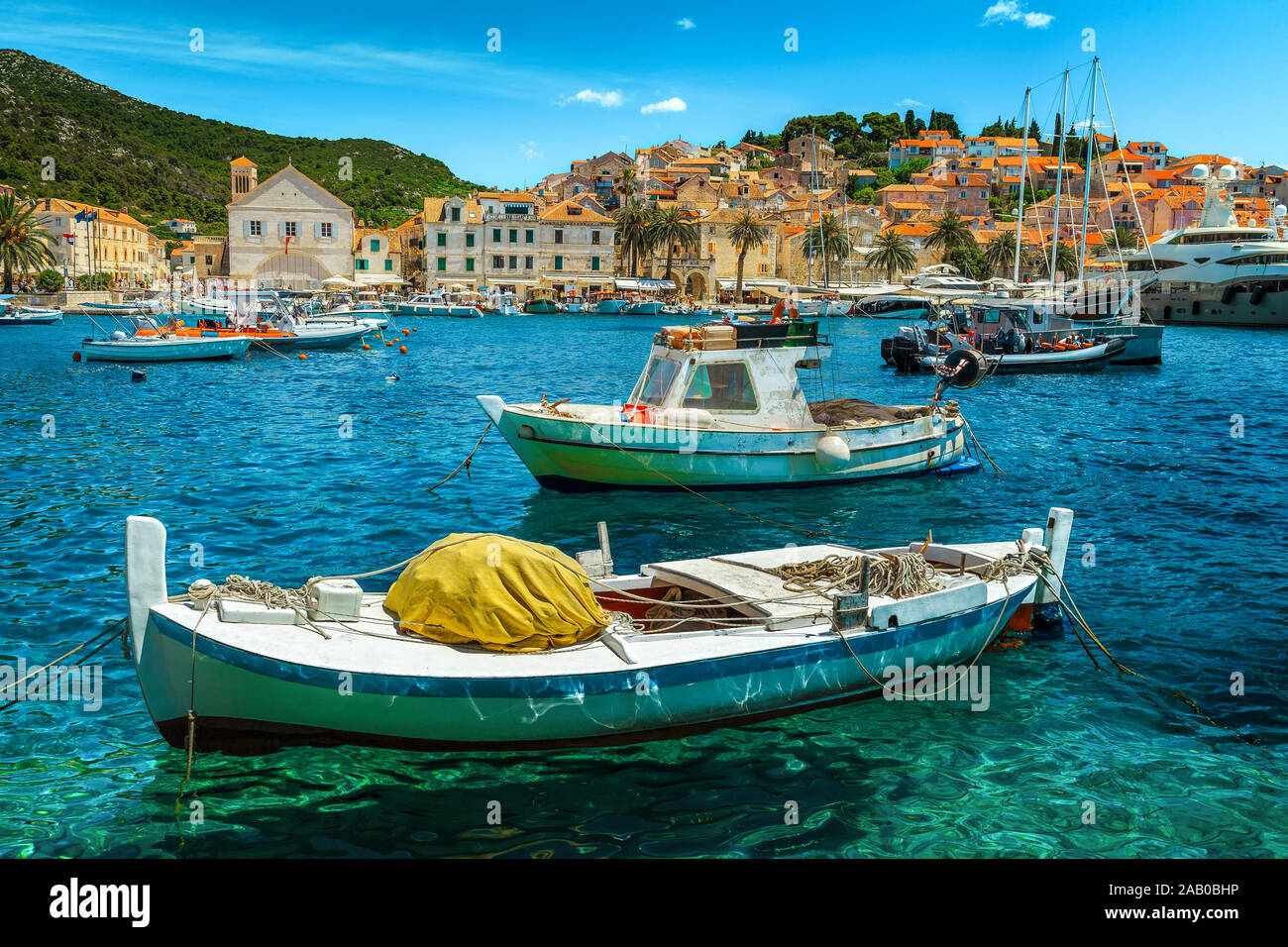 Fantastic medieval mediterranean resort with amazing harbor and spectacular cityscape. Luxury yachts and fishing boats moored in Hvar town harbor, Hva Stock Photo