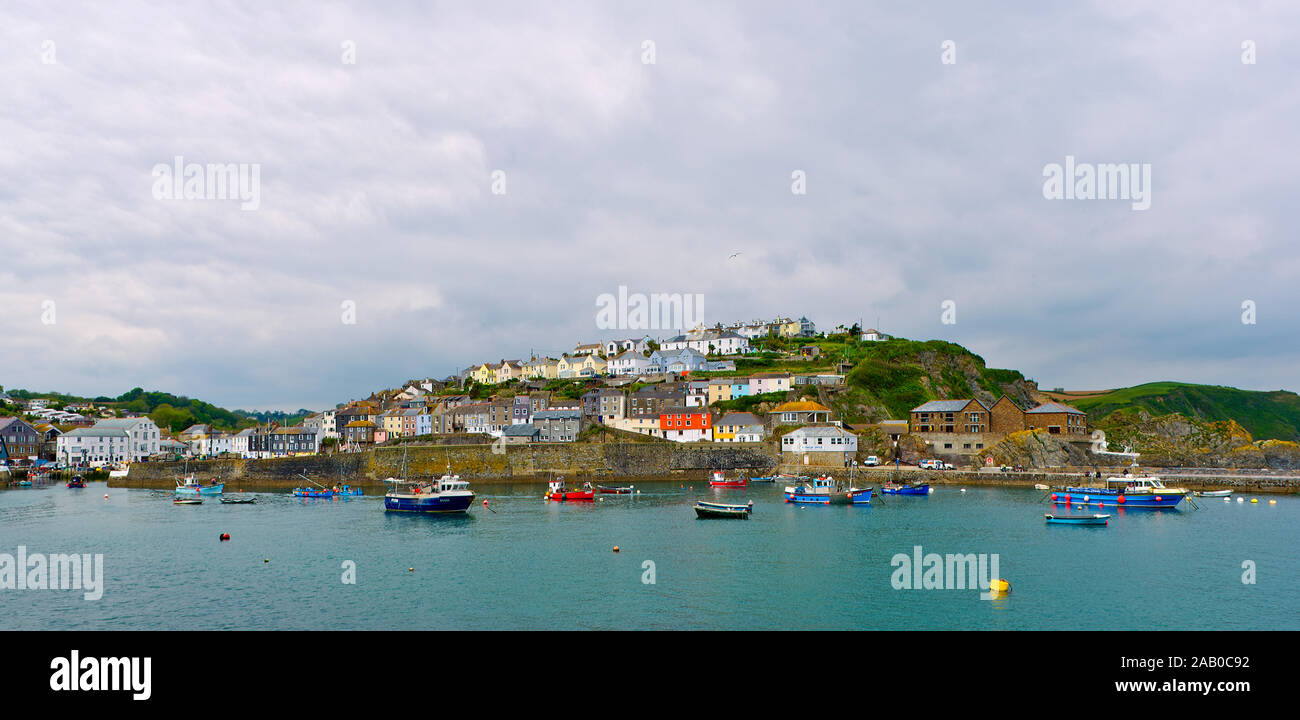Mevagissey fishing port and harbour in the English county of Cornwall. Beautiful houses and shops as well as a lighthouse bring many summer visitors. Stock Photo