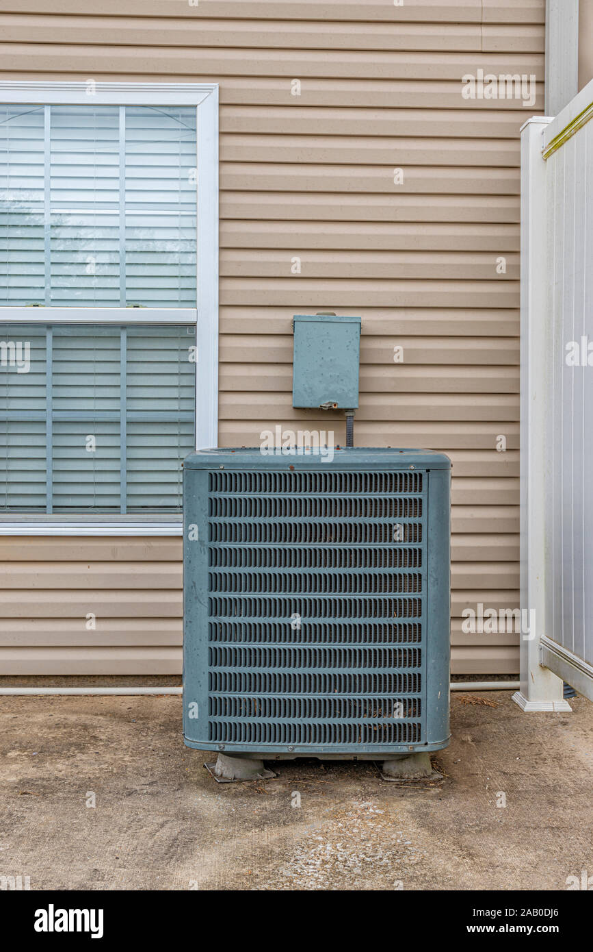 Vertical shot of an air conditioning unit on the patio behind a condo