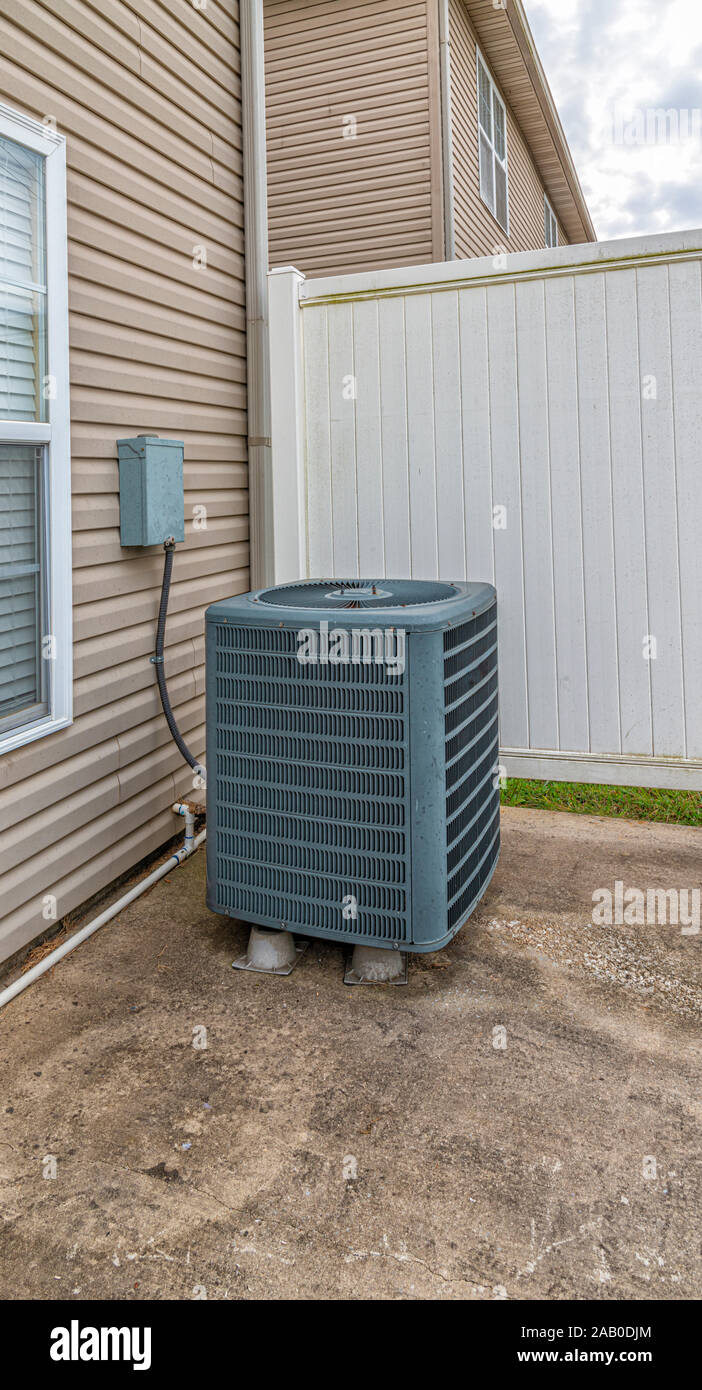 Vertical shot of an air conditioning unit on the patio behind a condo