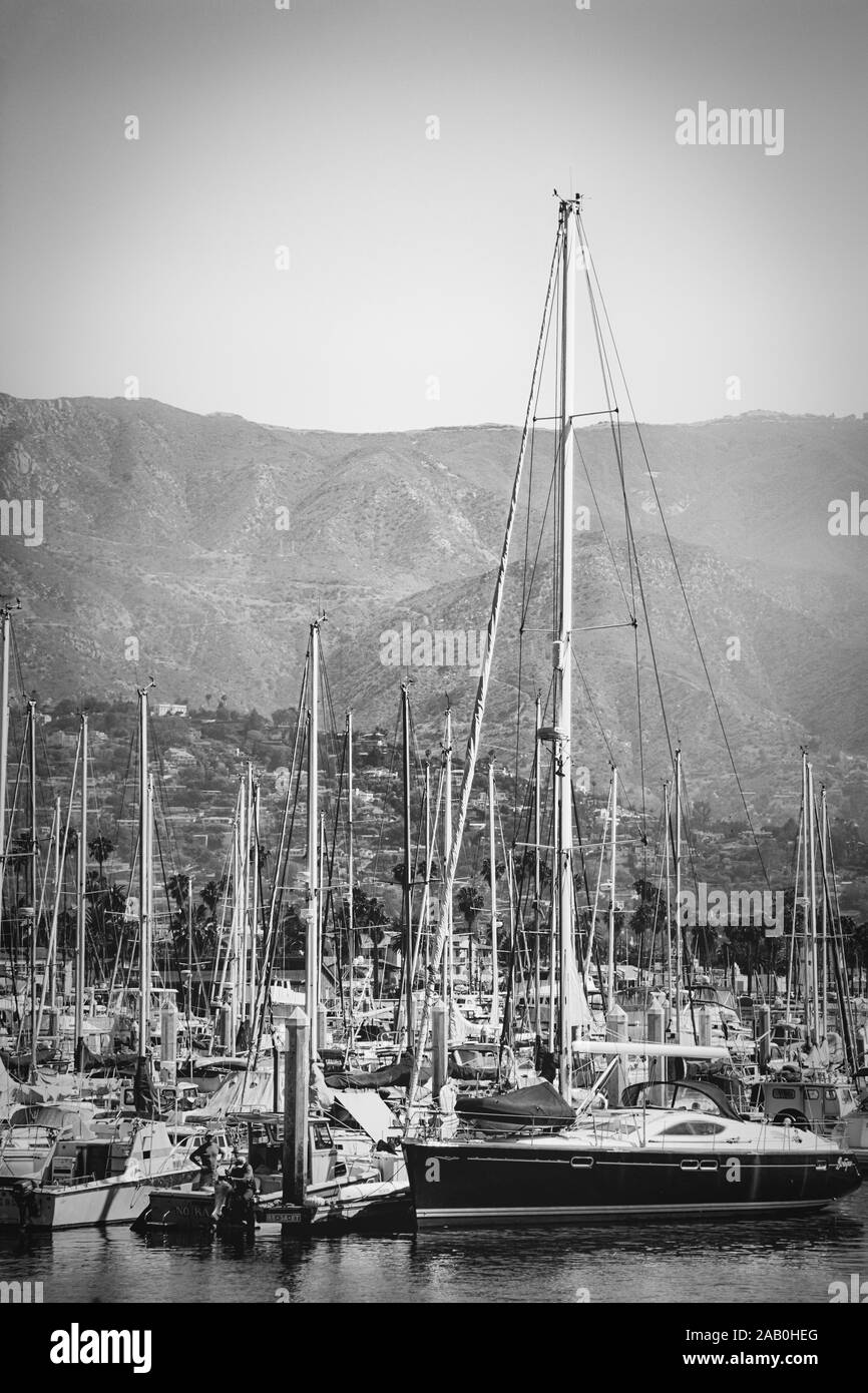 Mostly Sailboats, docked at the marina in the Santa Barbara Harbor with a distant view of the Santa Ynez mountains and foothills in Santa Barbara, CA Stock Photo