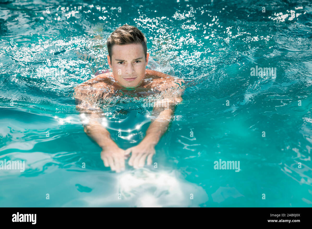 Ein junger Mann, der im Schwimmbecken schwimmt Stock Photo