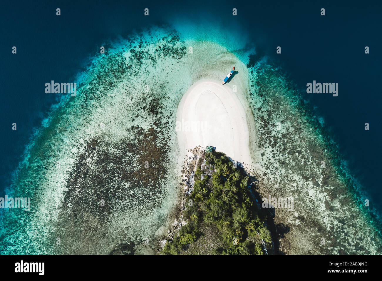 Aerial view of white sand beach on small tropical coral reef island ...