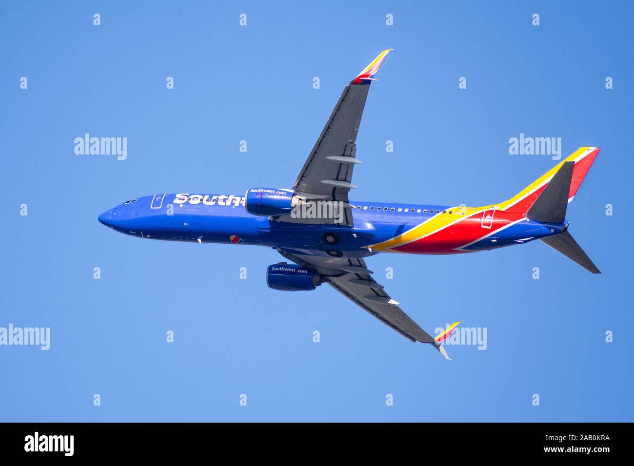 Nov 21, 2019 San Jose / CA / USA - Southwest Airlines aircraft in flight; the Southwest Airlines heart Logo visible on the airplanes' underbelly; blue Stock Photo