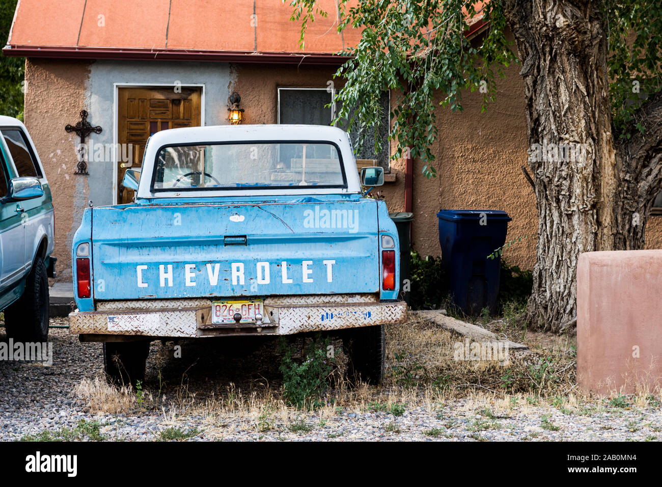 Santa Fe, New Mexico, USA, house, home, residence with old Chevrolet pick up truck in front yard. Stock Photo