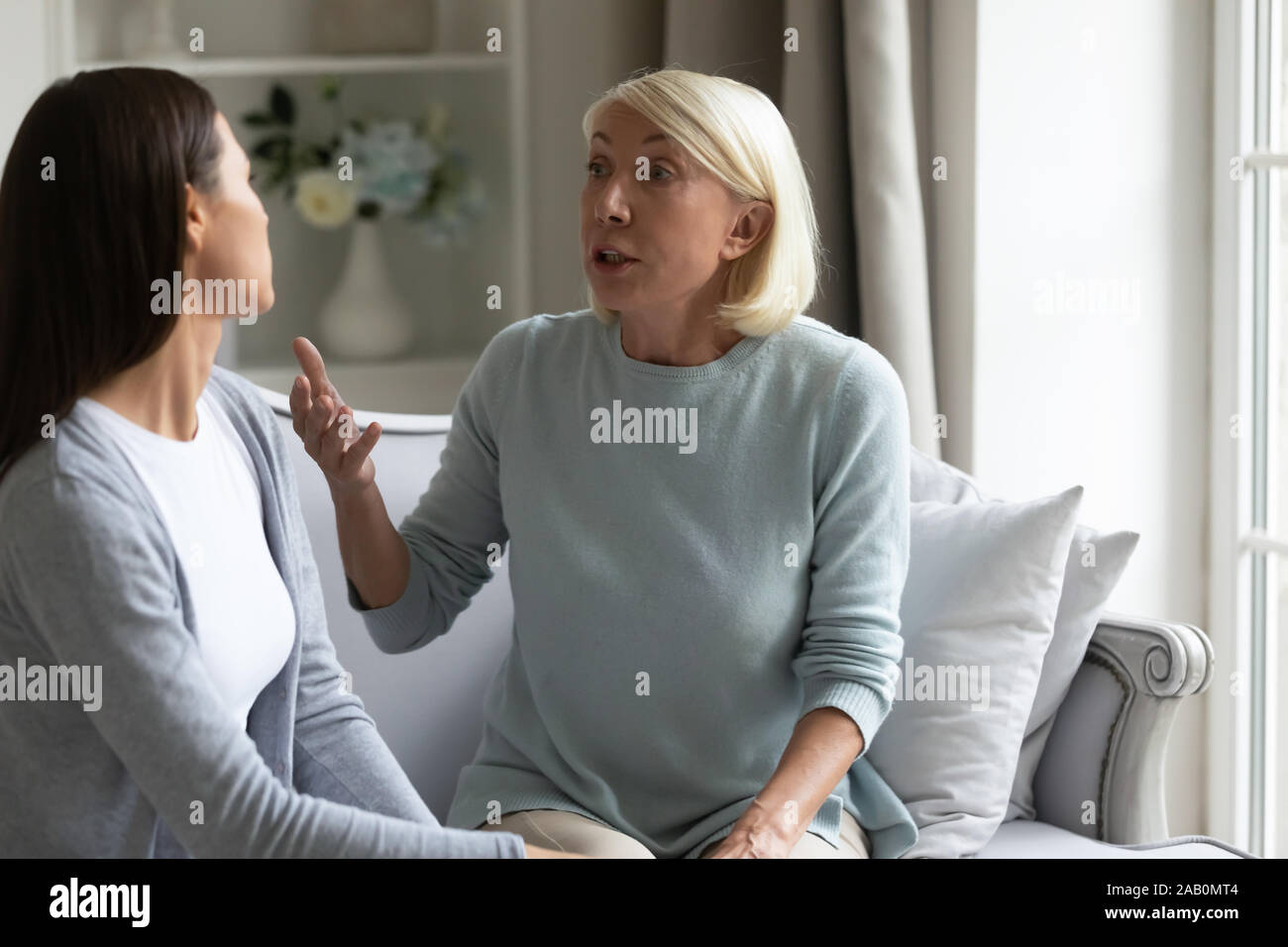 Angry 50s mother having dispute with grown up daughter Stock Photo