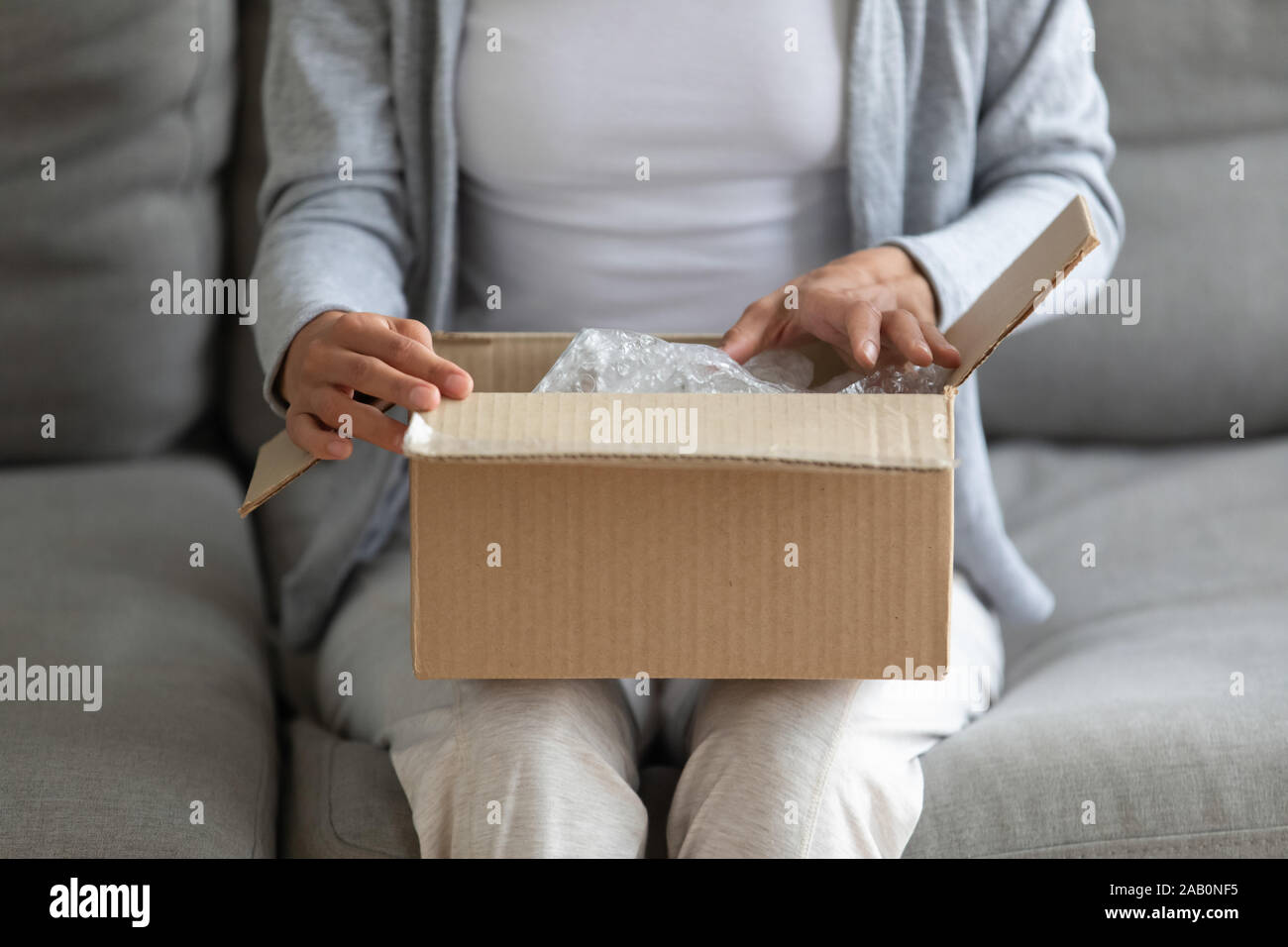 Close up view on woman lap is small carton box Stock Photo