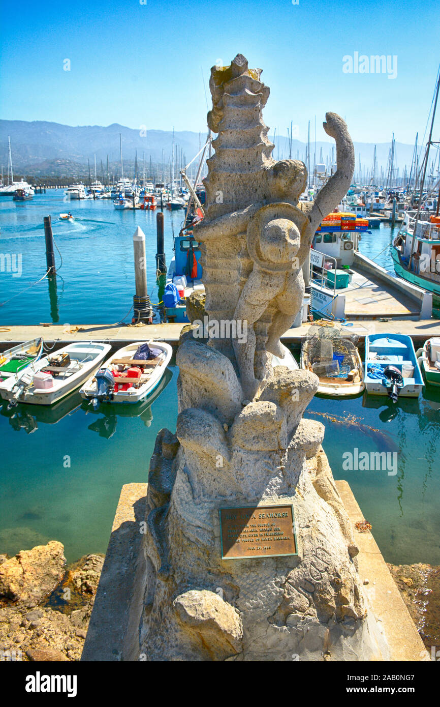 'Boy on a Seashore' stone sculptor, a gift from Puerto Vallarta, MX, overlooks the boat filled marina at the Santa Barbara Harbor in Santa Barbara, CA Stock Photo