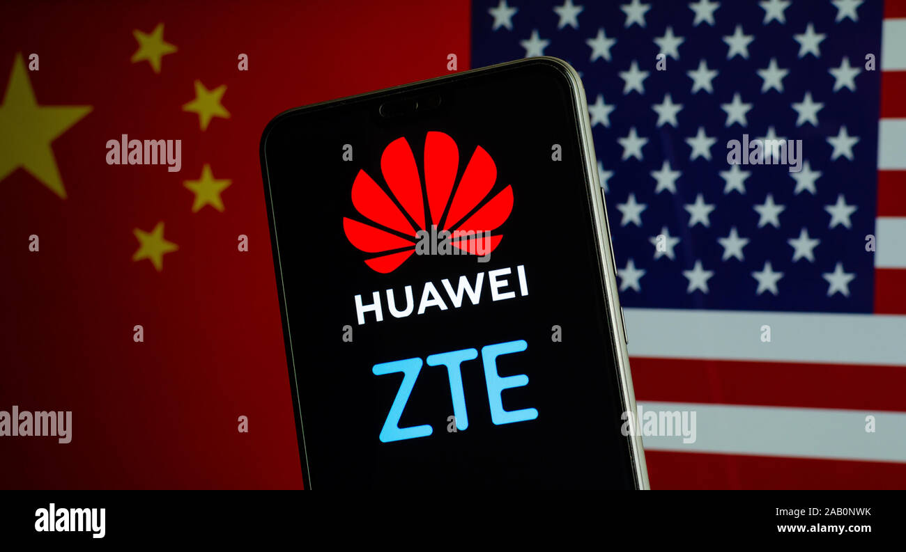 Huawei ZTE logos on a smartphone and flags of China and US on the blurred background. The firms are in the centre of US - China tensions Stock Photo