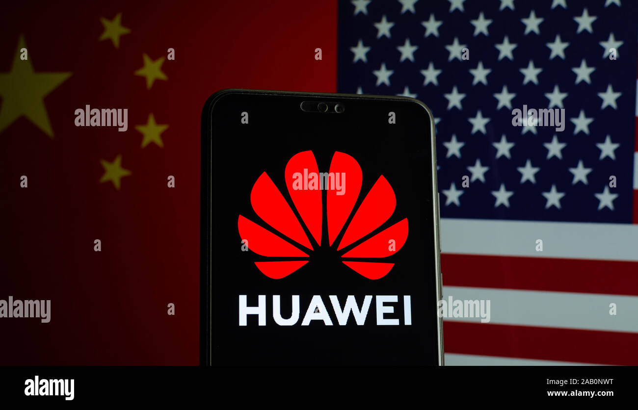 Huawei logo on a smartphone and flags of China and US on the blurred background. Stock Photo