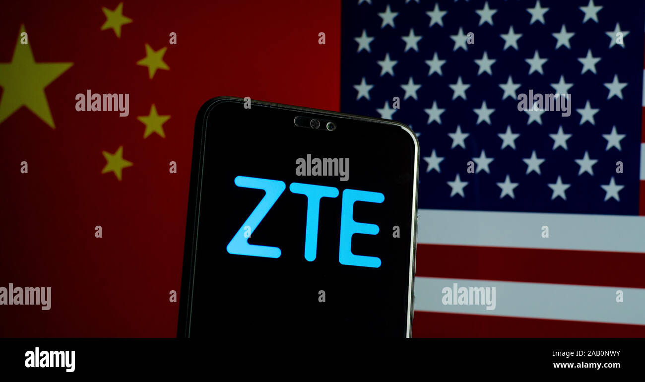 ZTE logo on a smartphone and flags of China and US on the blurred background. ZTE is leading 5G equipment manufacturer which is blacklisted in the USA Stock Photo