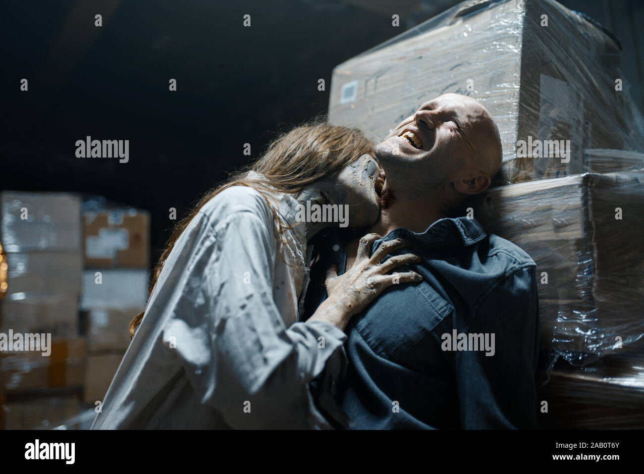 Female zombie bites a man in the neck, death trap Stock Photo Alamy