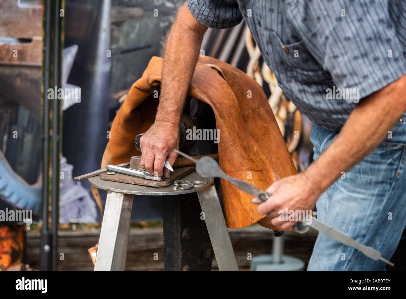 blacksmith gesture on his anvil Stock Photo - Alamy