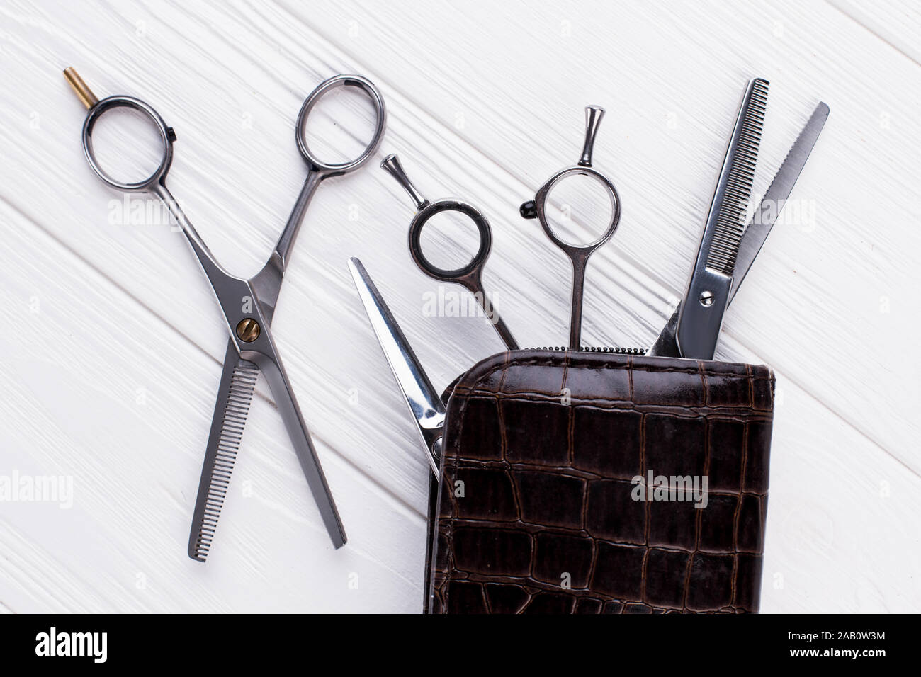 Professional hairdresser scissors on wooden background. Stock