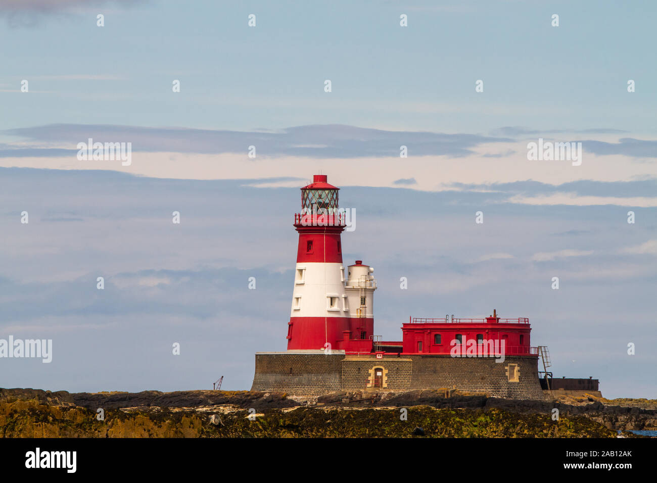 Longstone Lighthouse in white and red, on Longstone Rock in the outer group of the Farne Islands off the Northumberland Coast Stock Photo