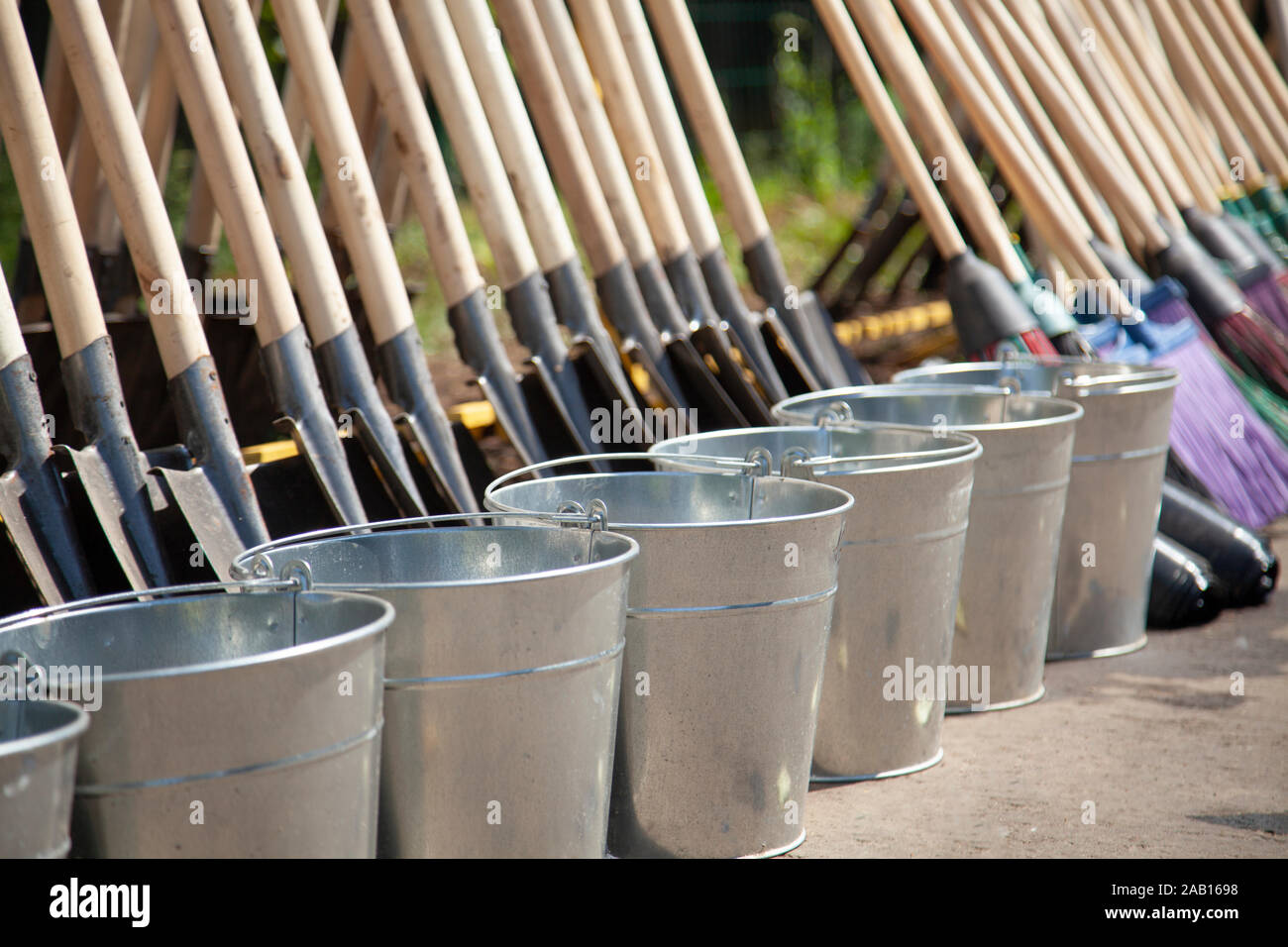 Gardener's tools on the street. Many tools for planting trees. Shovels