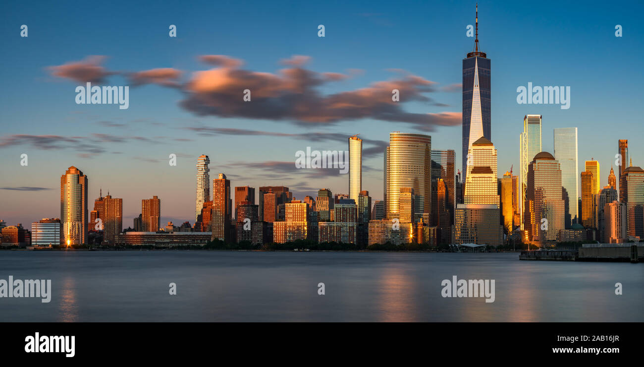 Sunset on the Lower Manhattan skyscrapers of Lower Manhattan (World Trade Center) from the Hudson River. Financial District, New York City, NY, USA Stock Photo