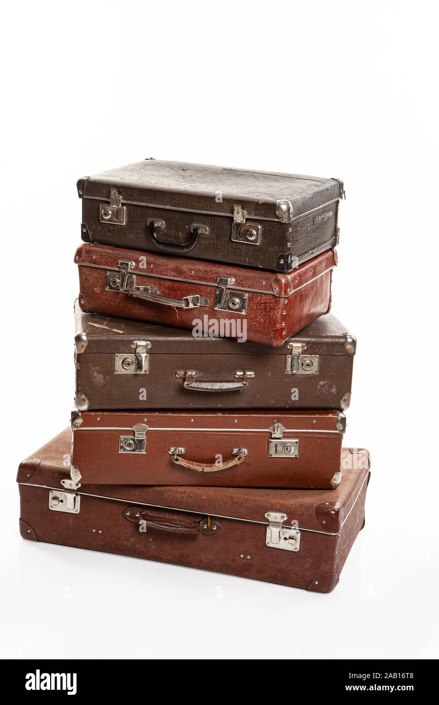 Five old suitcases on an isolated studio background Stock Photo